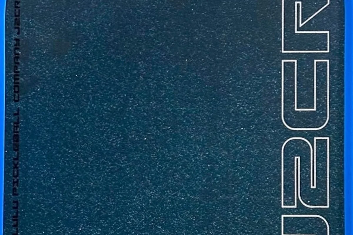 Close-up of the Honolulu J2CR's Crystal Blue face, a dark blue surface covered in fine white grit flecks